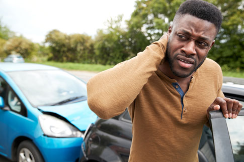 Man holding neck after car accident